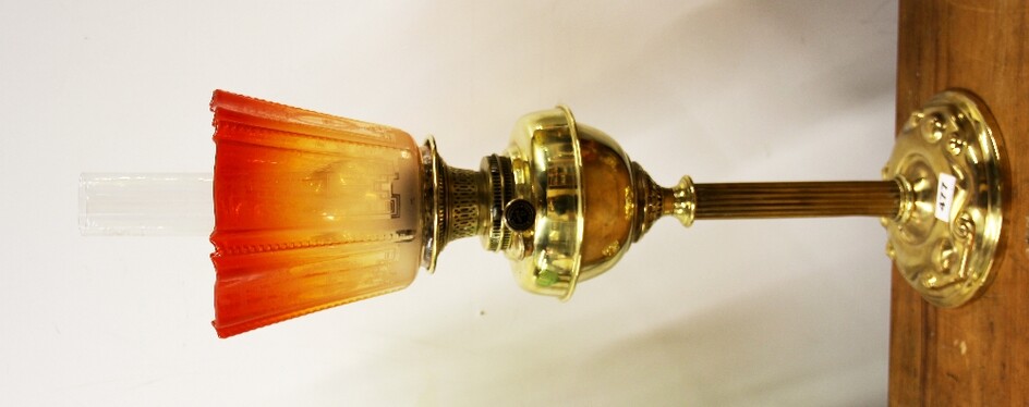 An unusual Art Nouveau brass oil lamp with original etched vivid orange shade, overall H. 74cm.