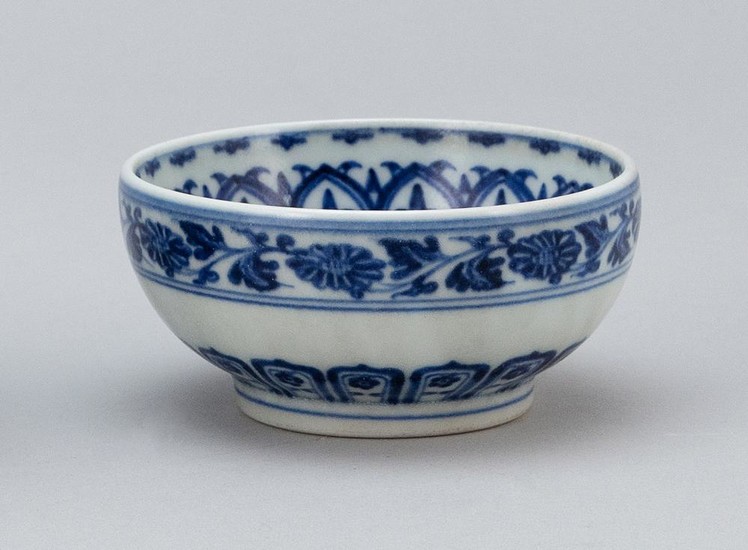 CHINESE BLUE AND WHITE PORCELAIN BOWL Bands of lotus flowers and vines about the interior and exterior. Four-character Kangxi mark o...