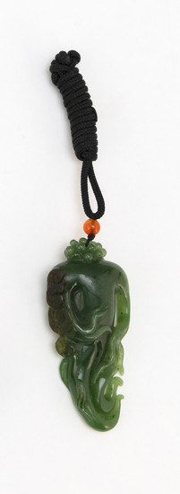 CHINESE CARVED SPINACH GREEN JADE PENDANT In the form of a buddha's hand fruit. Length 2.75". Suspended from a black silk cord.