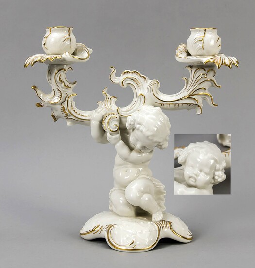 Figural candlestick, Hutschenreuther, Selb, brand of the art department 1955-69, beige fragments, gold-plated, designed by Karl Tutter, inscribed, kneeling putto on a four-legged pedestal carrying the two-lamp candlestick, h. 28 cm, w. 26 cm
