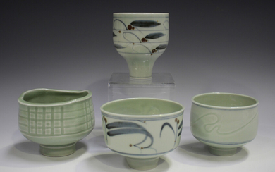 Four Derek Clarkson studio porcelain footed bowls, each decorated with a celadon glaze, two with cob