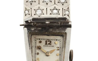 Hamilton. A platinum and diamond set bracelet with concealed manual wind watchCirca...