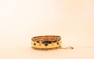 Open cuff bracelet in 18K yellow gold set with diamonds and sapphires between two rows of small pearls, l. 6.5 cm, weight approx. 33 g. [small lacks].