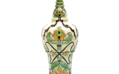 Polychrome painted earthenware vase and cover with a stylised decoration...