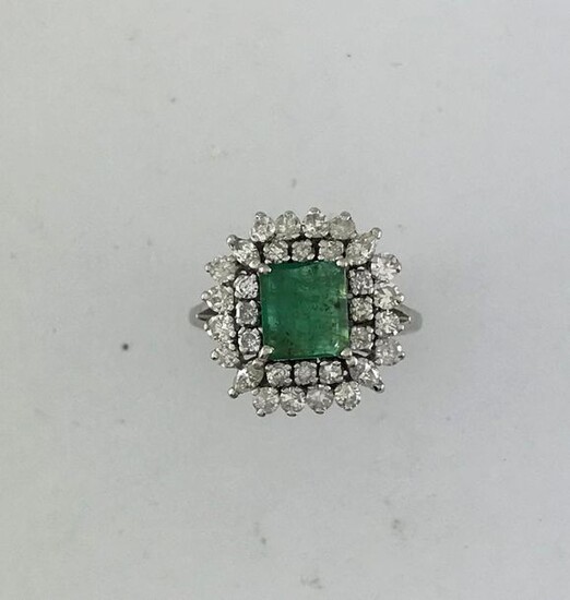 Ring in white gold 750°/°°° set with an emerald in a double entourage of round and shuttle diamonds, Finger size 54, Gross weight: 7,05g