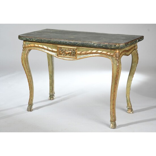 TABLE CONSOLE LOUIS XV en bois rechampi et doré. Elle est à décor sculpté d’un...