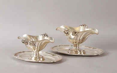 TWO SAUCIERES with fixed tray, in silvery metal, decorated with nets and handles with windings and foliage. Goldsmith: L. AUZOLLE. H: 14 cm and 12 cm. (unsilvered)
