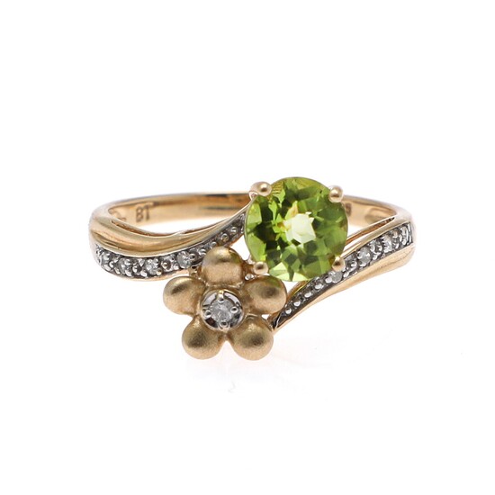 a peridot and diamond ring set with a circular-cut peridot and numerous brilliant and single-cut diamonds, mounted in 14k gold. Size app. 57.5.
