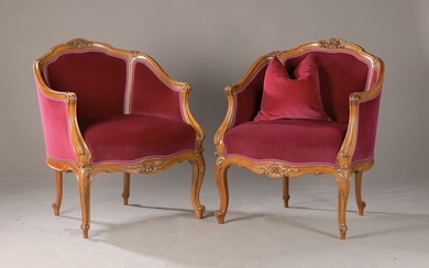 pair of finely carved bergeres or armchairs, around...