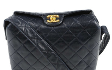 CHANEL - a vintage navy blue quilted handbag. View more details