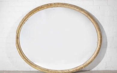 A Neoclassical style carved giltwood oval mirror