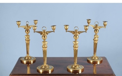 A set of four Empire ormolu twin light candelabra
