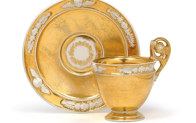 A gilt cup with gilt saucer