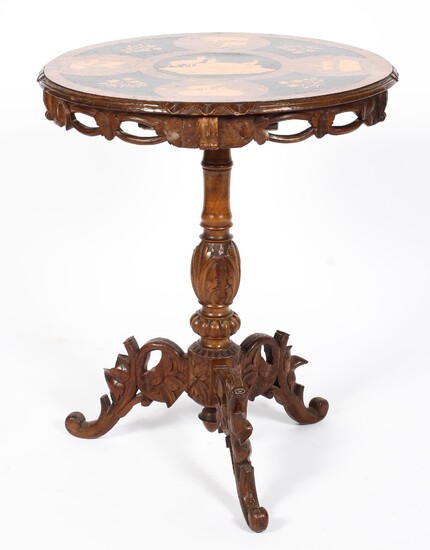 A 19th century Austrian Black Forest carved centre table with penwork decorated top