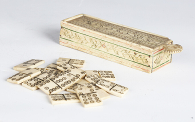 A 19th century prisoner-of-war carved bone games box with sliding cribbage board lid, containing a s