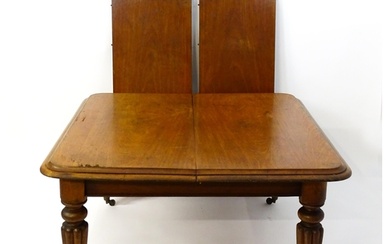A 19thC mahogany dining table with a moulded top above turne...