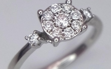 A 9 K white gold ring with a diamond cluster and a single di...