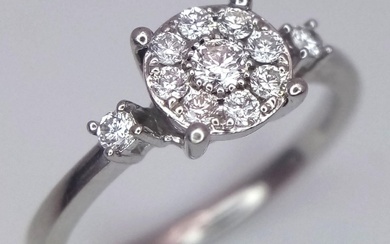 A 9 K white gold ring with a diamond...