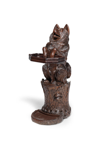 A Black Forest late 19th/ early 20th century carved linden wood stick and umbrella stand