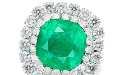 A COLOMBIAN EMERALD AND DIAMOND CLUSTER RING set with a cushion cut emerald of approximately 6.25...