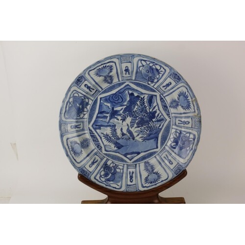 A Chinese, Kangxi, Kraak blue and white dish decorated to th...