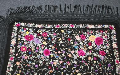 A Chinese black silk shawl, 20th century, finely worked in coloured threads with a design of peony