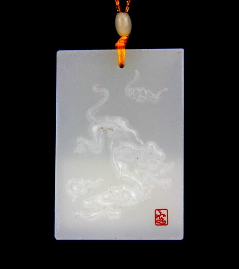 A Chinese carved white jade amulet of a tiger on white jade bead necklace.
