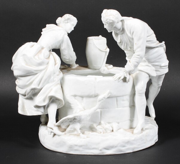 A Continental porcelain figure group beside a well, late 19th century
