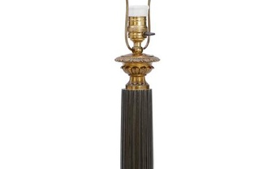 A French Louis-Philippe patinated and gilt bronze lamp, fluted stem on a...