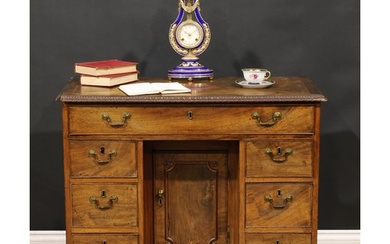 A George III mahogany kneehole desk, rectangular top with mo...
