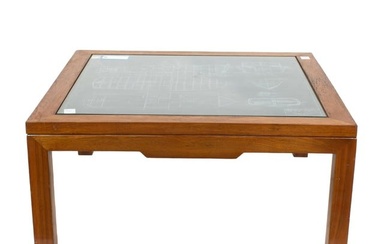 A Mid Century Modern teak coffee table with a slate 'blueprint' of a power cruiser