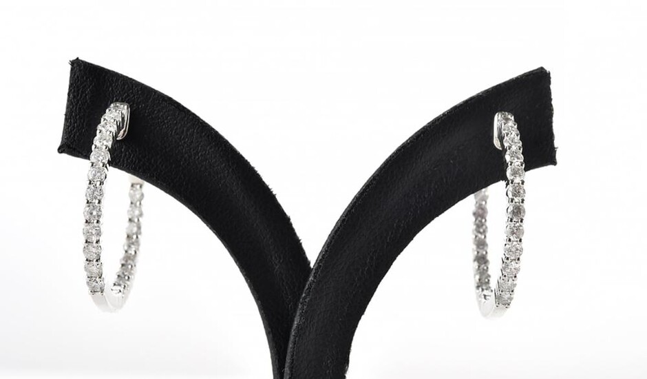 A PAIR OF DIAMOND HOOP EARRINGS Each earring comprising twenty round brilliant cut diamonds, altogether totalling 1.61cts, in 18ct w...