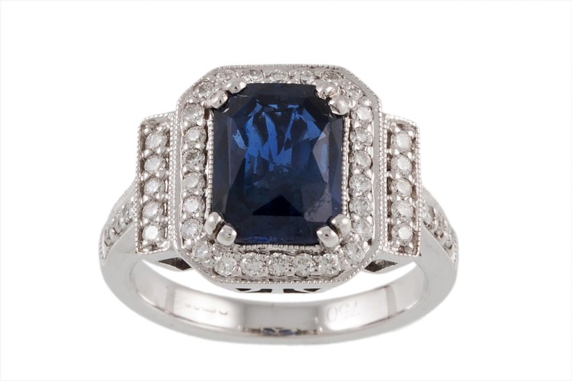 A SAPPHIRE AND DIAMOND CLUSTER RING mounted in 18ct white go...