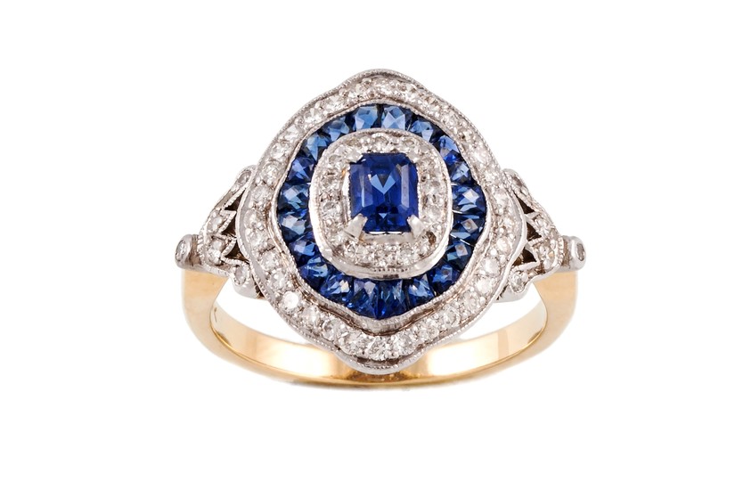 A SAPPHIRE AND DIAMOND TARGET CLUSTER RING, with sapphires o...