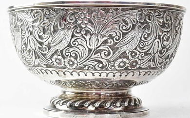 A Victorian silver bowl with embossed decoration of birds within...