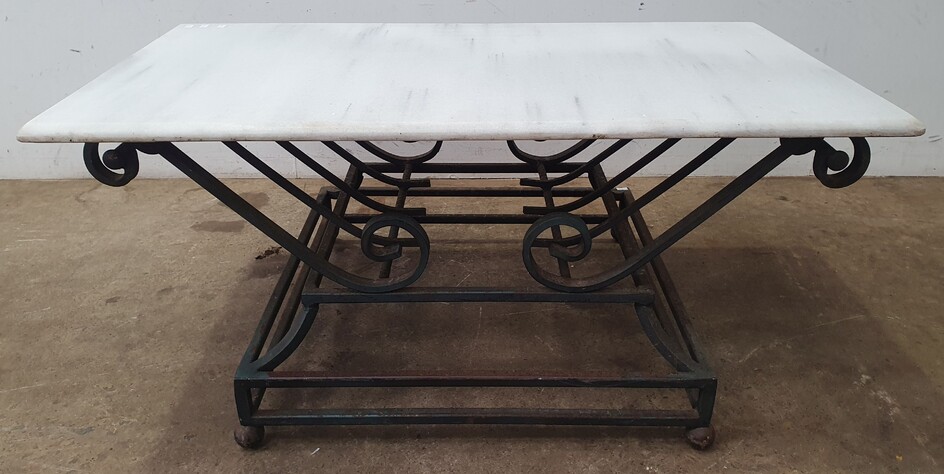 A WROUGHT IRON BASED MARBLE TOP COFFEE TABLE