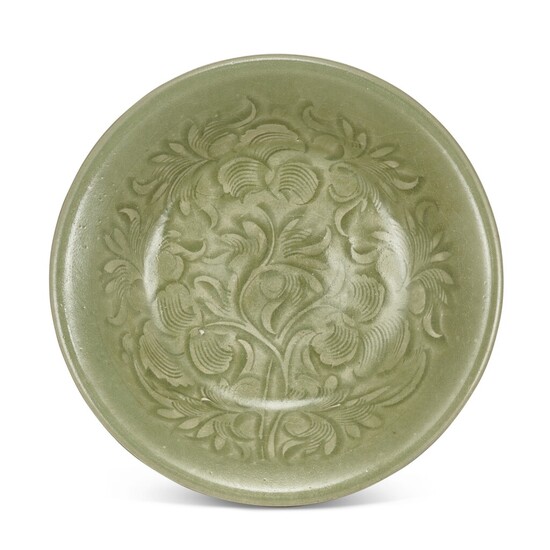 A carved Yaozhou celadon 'peony' shallow bowl, Northern Song dynasty 北宋 耀州青釉刻纏枝牡丹紋淺盌
