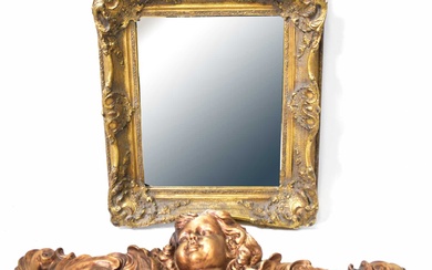 A gilt-framed wall mirror with bevel edged glass and Rococo-style...