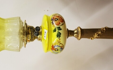 A large antique metal column oil lamp with yellow fount and etched yellow glass shade, overall H. 86cm.