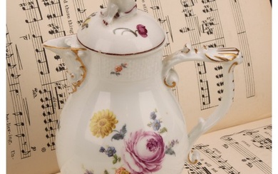 A mid 18th century Meissen baluster jug and cover, painted w...