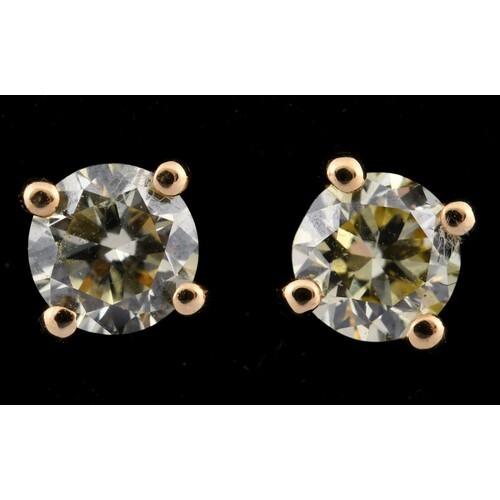 A pair of 18ct gold and diamond solitaire stud earrings