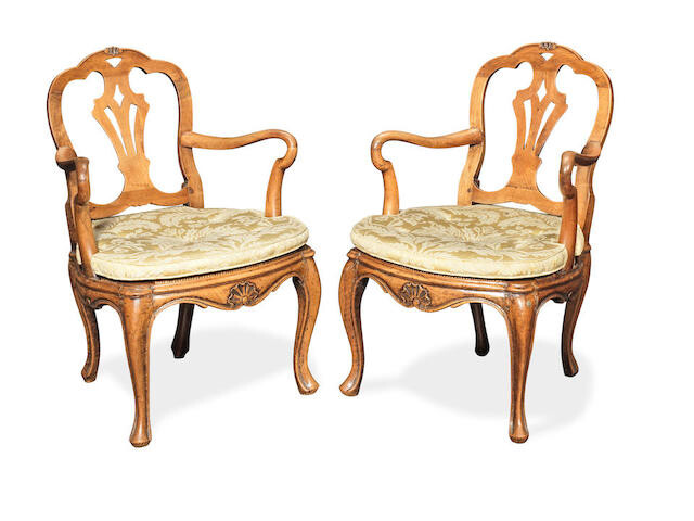 A pair of 18th Century Italian Provincial carved walnut open armchairs