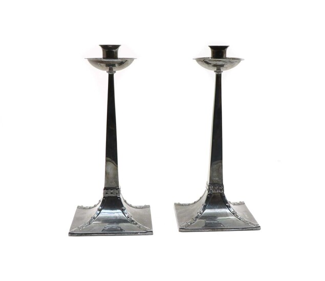 A pair of Arts and Crafts-style silver candlesticks