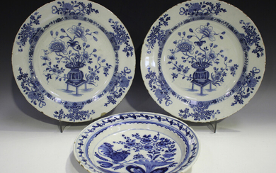 A pair of English Delft chargers, mid-18th century, each painted in blue with a central vase of flow