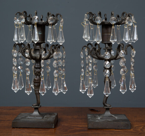 A pair of antique bronze candlesticks