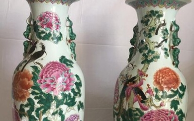 A pair of large polychrome porcelain vases decorated...