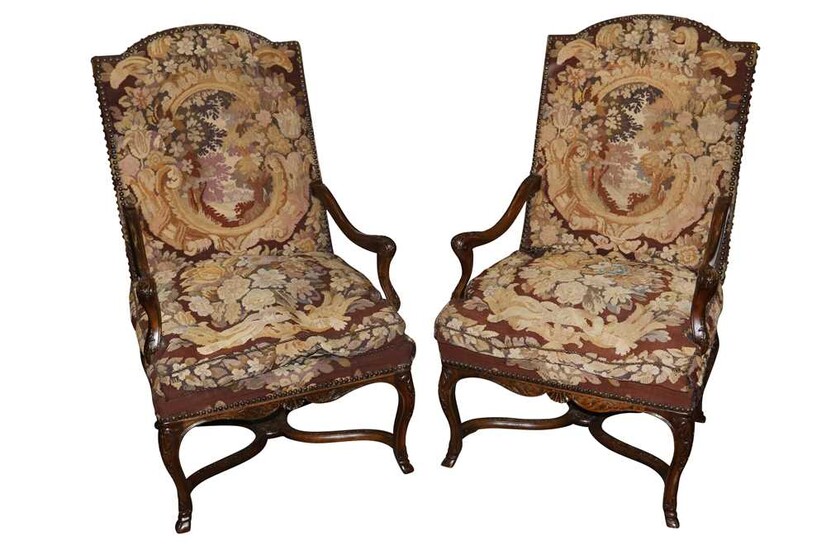 A pair of mid 18th Century style carved mahogany open armchairs