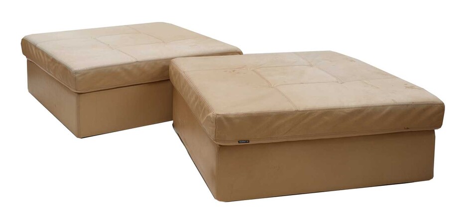 A pair of tan leather pouffes