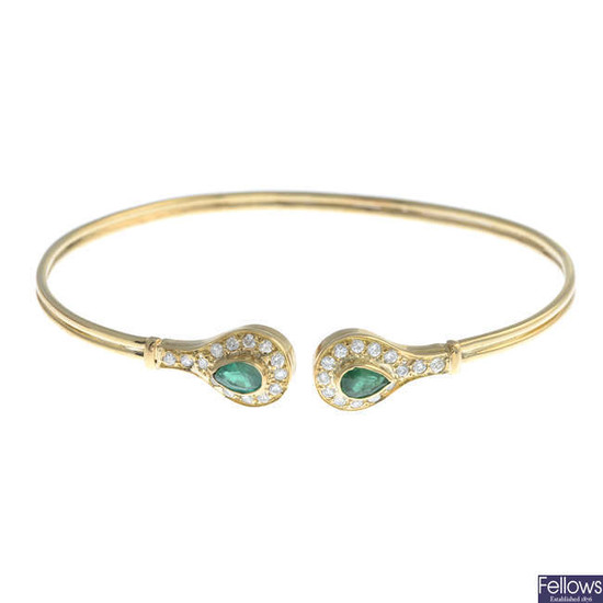 A pear-shape emerald and brilliant-cut diamond cluster terminal cuff bangle.