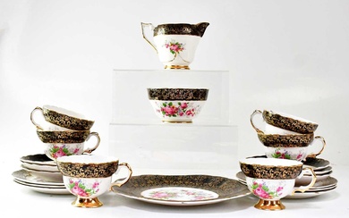 A porcelain part tea service printed with pink roses in...